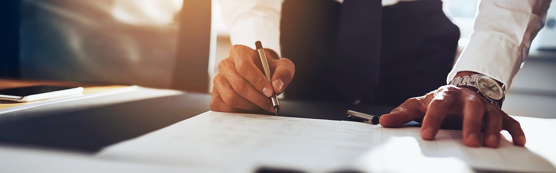 Man Signing on document